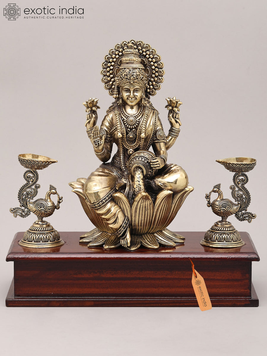 9" Four Armed Goddess Lakshmi Brass Idol with Peacock Lamp and Wood Base