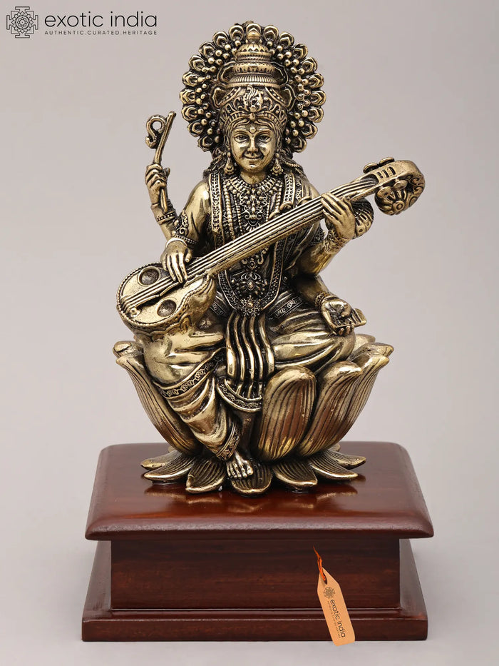 Seated Four Armed Saraswati Brass Idol with Wood Base