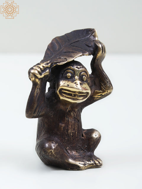 Small Brass Monkey Holding a Leaf Over Its Head