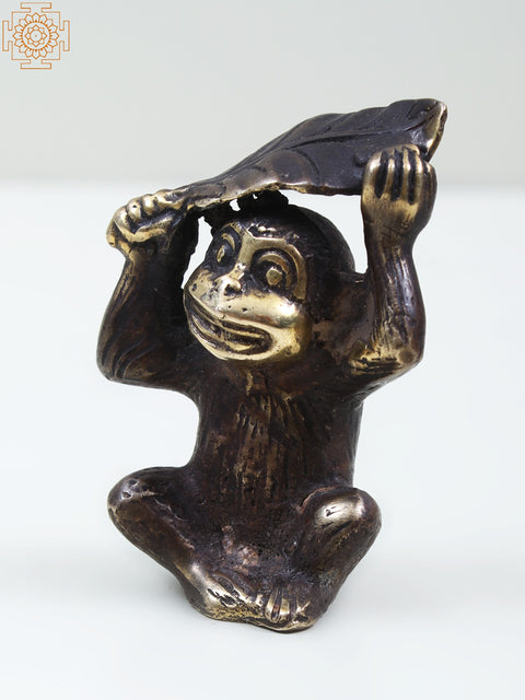 Small Brass Monkey Holding a Leaf Over Its Head
