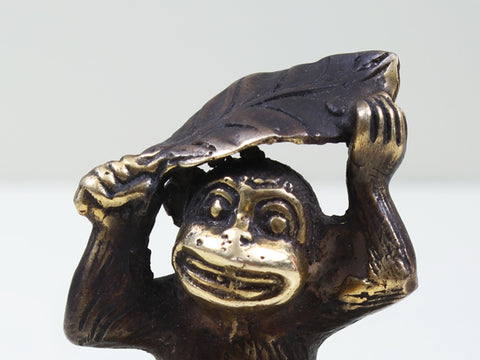 Small Brass Monkey Holding a Leaf Over Its Head