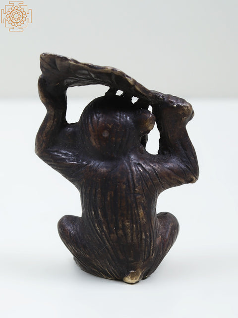 Small Brass Monkey Holding a Leaf Over Its Head