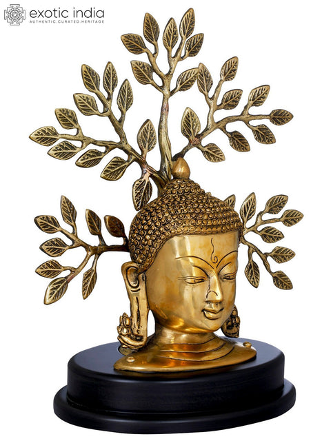 Lord Buddha Mask On a Wooden Base and Tree as a Backdrop