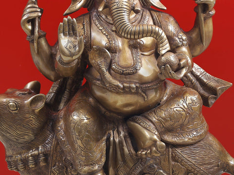 23" Ganesha Seated on His Rat Wearing a Leafy Crown In Brass