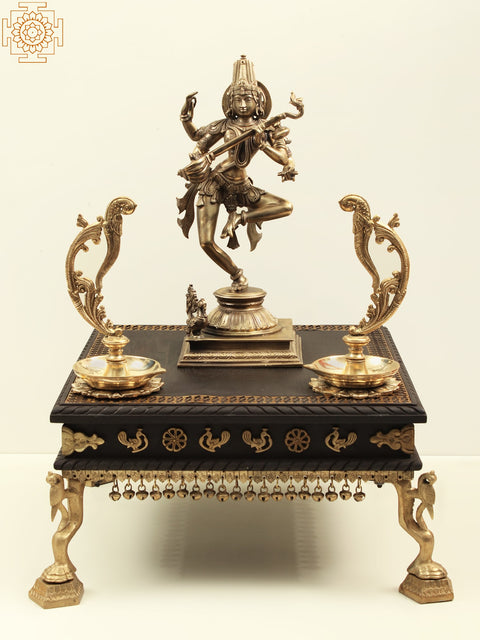 Wooden pedestal with Brass Ghungroos, Figures and Parrot Legs